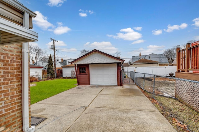 detached garage with concrete driveway and fence