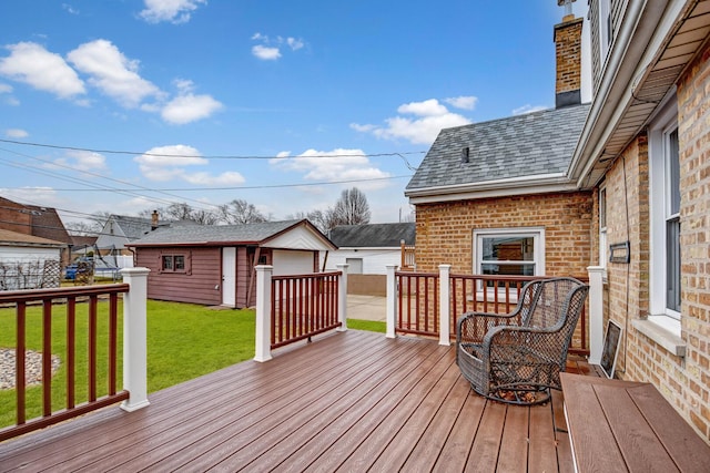 wooden terrace with an outbuilding and a lawn