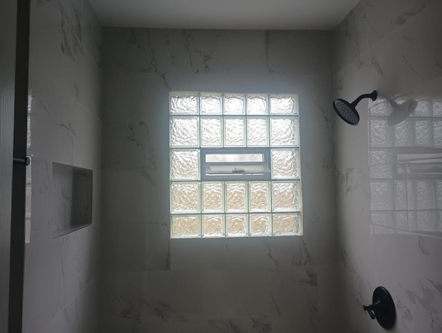 interior details with a tile shower