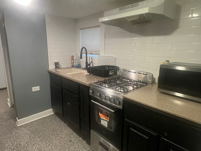 kitchen featuring range with gas cooktop, stainless steel microwave, under cabinet range hood, and dark cabinetry