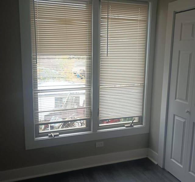 room details with baseboards and wood finished floors