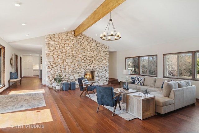 living room featuring a stone fireplace, a notable chandelier, vaulted ceiling with beams, and wood-type flooring