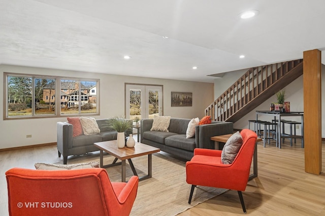 living room with recessed lighting, baseboards, wood finished floors, and stairs