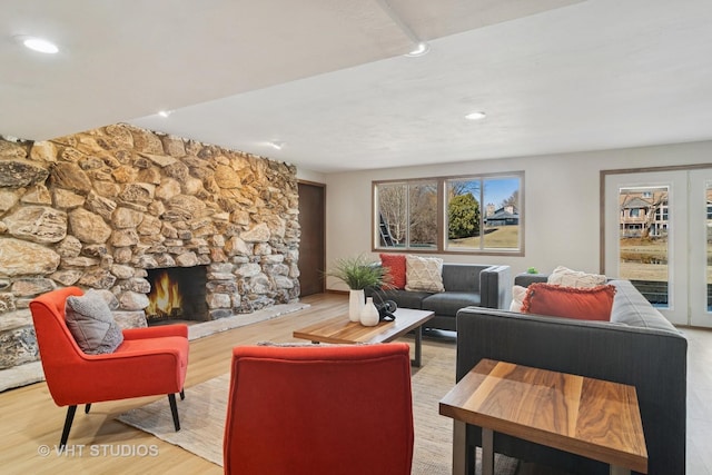 living room featuring wood finished floors, recessed lighting, and a fireplace