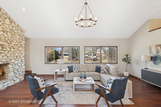 living room featuring a stone fireplace, wood finished floors, baseboards, and high vaulted ceiling