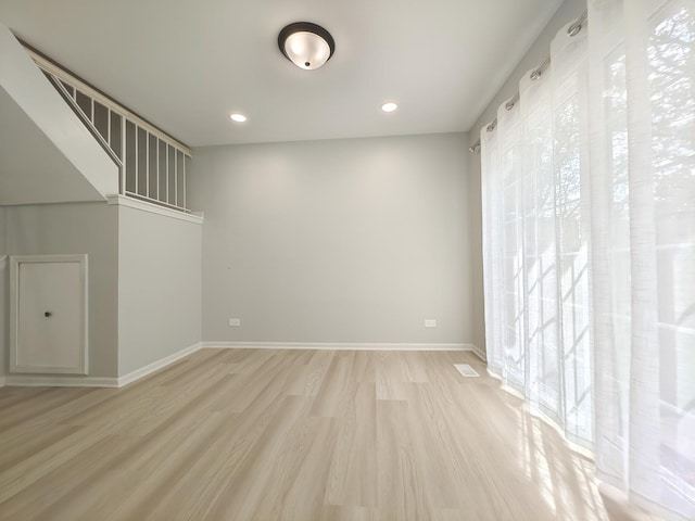 unfurnished room featuring light wood-style floors, baseboards, and recessed lighting
