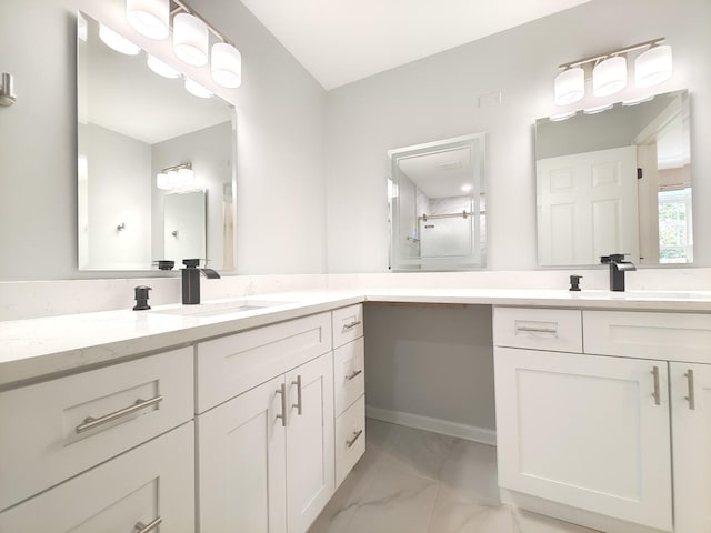 bathroom featuring marble finish floor and vanity