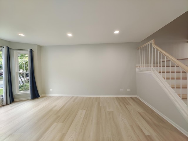 unfurnished room featuring recessed lighting, baseboards, and light wood finished floors
