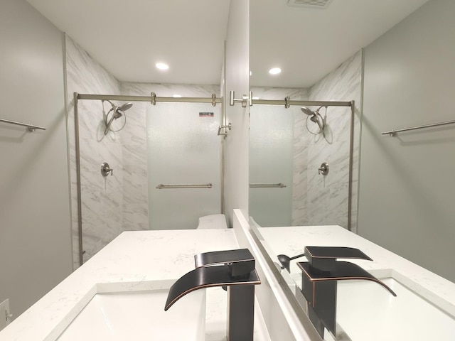 bathroom featuring recessed lighting, a shower stall, and vanity