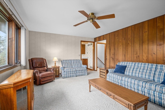 living area with carpet floors and ceiling fan