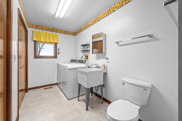 laundry room with laundry area, light tile patterned floors, visible vents, baseboards, and washing machine and clothes dryer