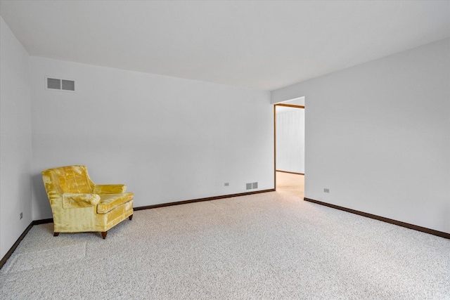 unfurnished room with carpet, visible vents, and baseboards