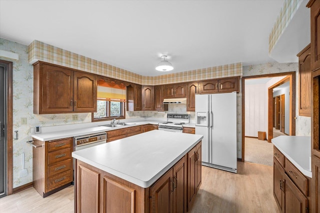 kitchen featuring light countertops, a kitchen island, white appliances, under cabinet range hood, and wallpapered walls