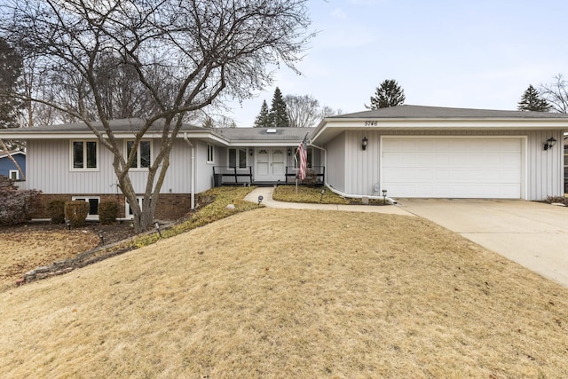 single story home featuring a garage, a front yard, and driveway