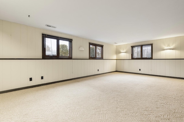 unfurnished room with visible vents and carpet flooring