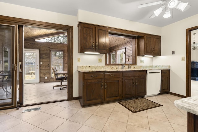 kitchen featuring visible vents, dishwasher, dark brown cabinetry, and light tile patterned flooring