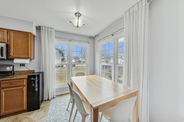 dining room featuring light tile patterned floors and beverage cooler