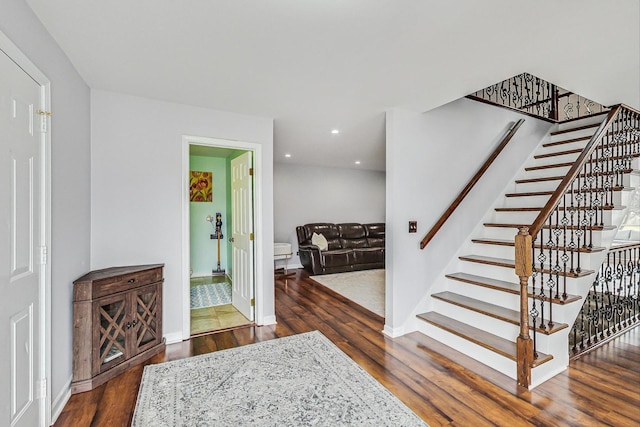 interior space with baseboards, wood finished floors, and recessed lighting