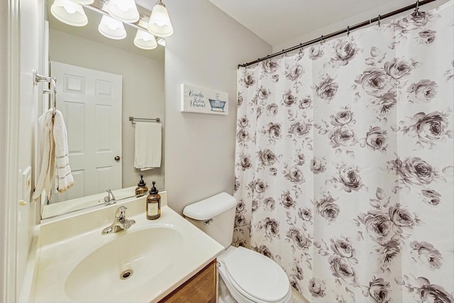 bathroom featuring toilet, a shower with curtain, and vanity