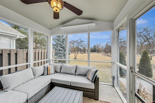 sunroom / solarium featuring a ceiling fan, a wealth of natural light, and vaulted ceiling