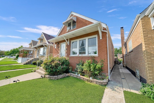 view of front of house featuring a front yard and brick siding