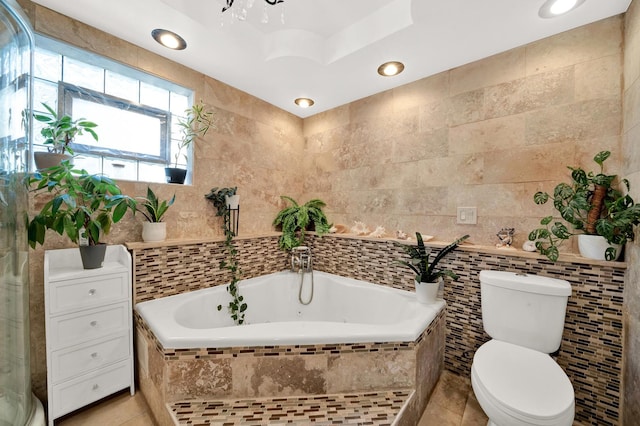 full bath with tile walls, recessed lighting, tile patterned floors, toilet, and a bath