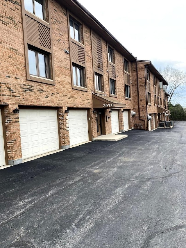 view of property featuring a garage and driveway