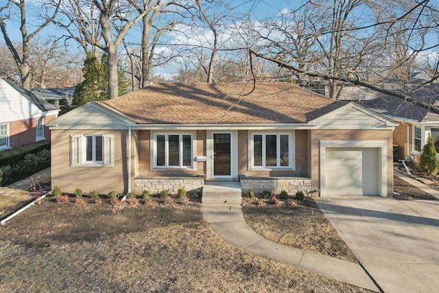 ranch-style home with a garage, brick siding, and a shingled roof