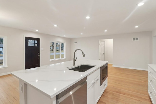 kitchen with a sink, stainless steel appliances, light wood-style flooring, and recessed lighting