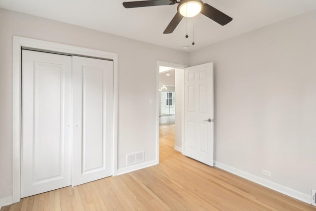 unfurnished bedroom with a ceiling fan, baseboards, visible vents, light wood-style flooring, and a closet