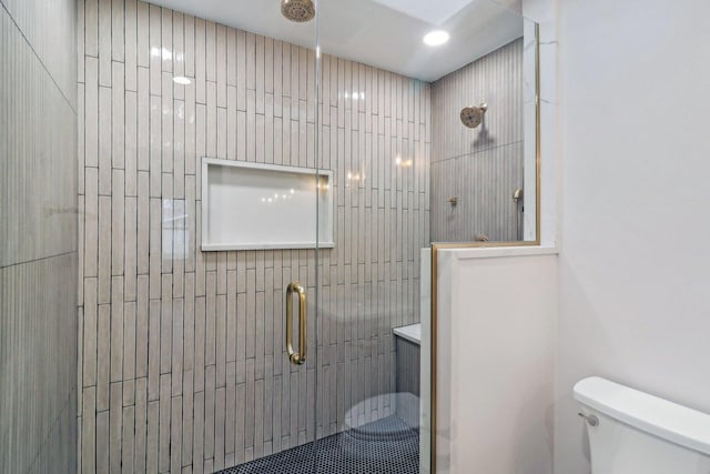 full bath featuring toilet and a tile shower