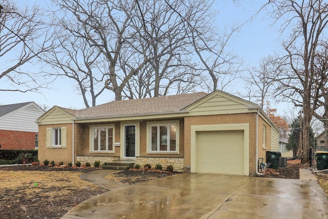 single story home with a garage, brick siding, stone siding, and driveway