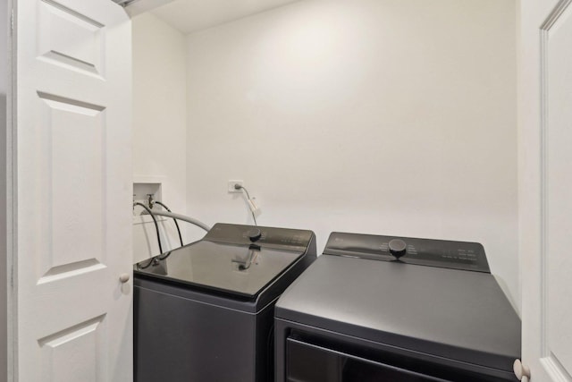 laundry room with washing machine and clothes dryer and laundry area