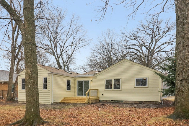 rear view of property with fence