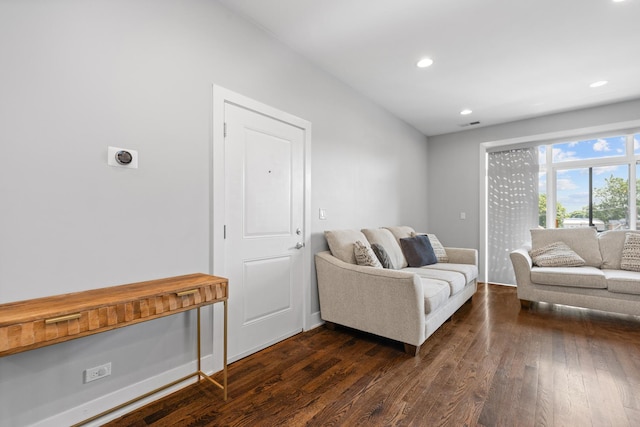 living area featuring recessed lighting, dark wood-style flooring, and baseboards