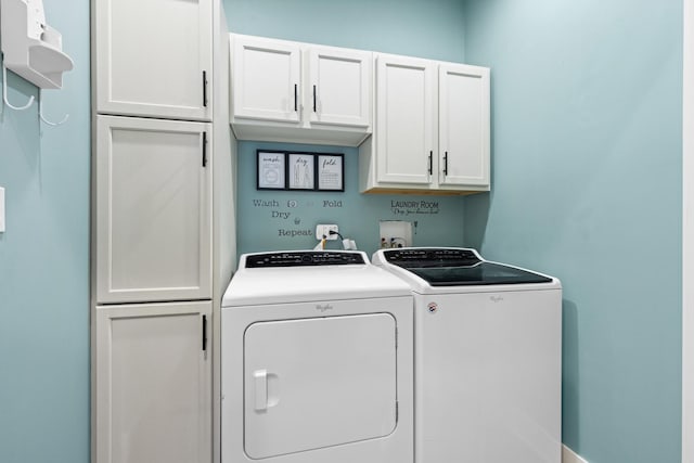 laundry area with cabinet space and separate washer and dryer