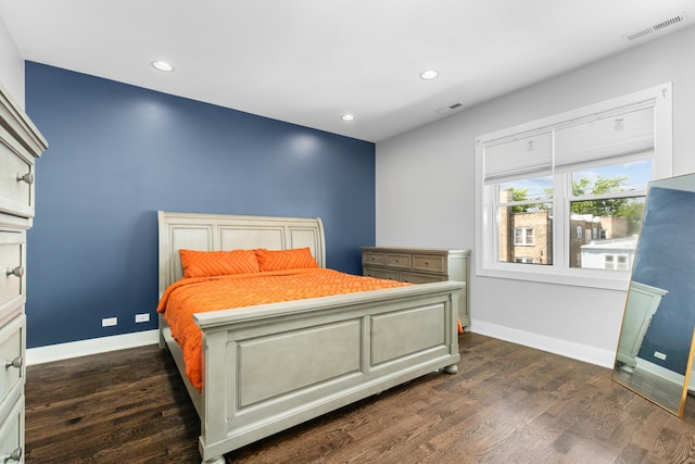 bedroom featuring dark wood finished floors, baseboards, and visible vents