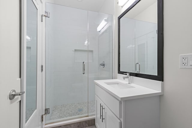 bathroom featuring vanity and a shower stall