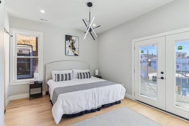 bedroom with access to outside, baseboards, wood finished floors, and french doors