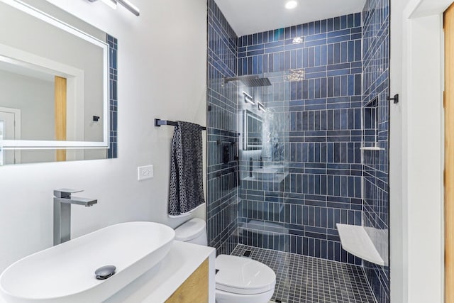 bathroom featuring vanity, toilet, and a walk in shower