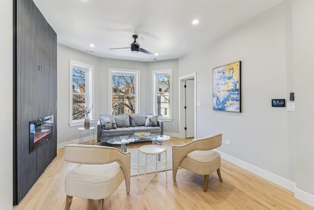 sitting room featuring light wood finished floors, recessed lighting, a ceiling fan, and baseboards