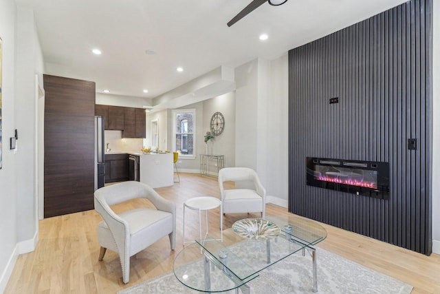 living room featuring recessed lighting, light wood-style flooring, and baseboards