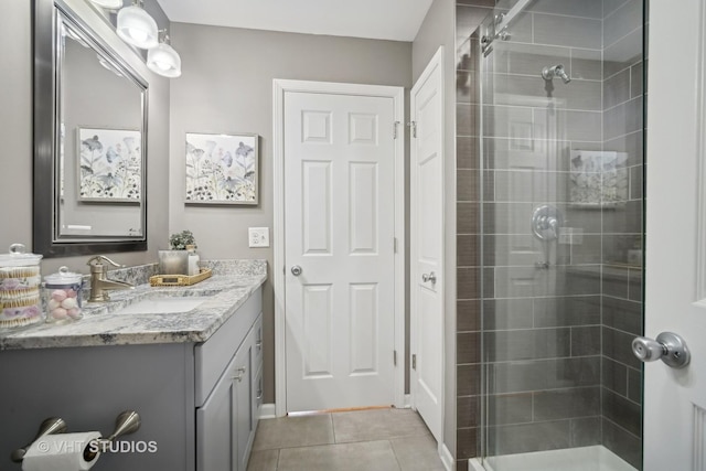 bathroom with a shower stall, vanity, and tile patterned floors