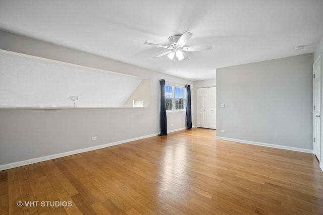 interior space featuring light wood-style floors, ceiling fan, and baseboards