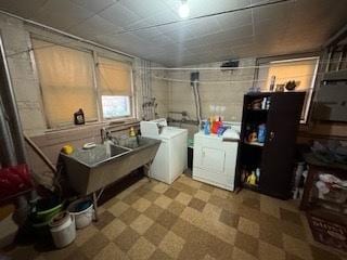 laundry room featuring laundry area, separate washer and dryer, and tile patterned floors