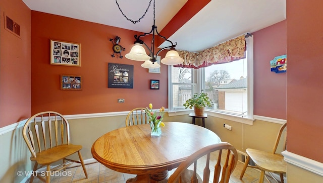 dining space featuring visible vents and a notable chandelier