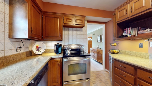 kitchen with appliances with stainless steel finishes, brown cabinetry, light stone countertops, and decorative backsplash