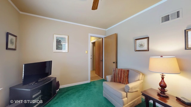 living area featuring ceiling fan, visible vents, baseboards, carpet, and crown molding