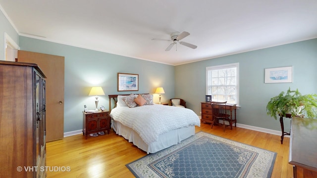 bedroom with light wood-style flooring, baseboards, and ceiling fan