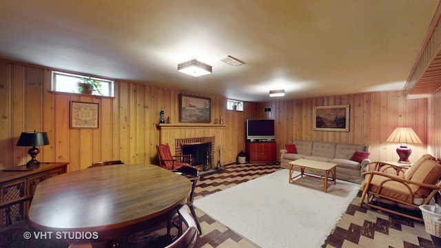 living area with visible vents, a fireplace, and tile patterned floors